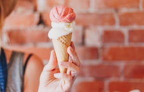 A hand holding an ice cream.