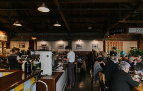 View of big table of customers at Addington Coffee Co-op in Christchurch.