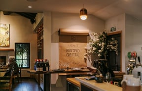 The interior of the Bistro Gentil with a big roll of brown paper with a hand written lettering on the wall.