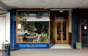 The blue and wooden exterior of Forest restaurant in Auckland.