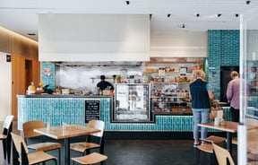 Bright turquoise counter and chef station at Foundation Café in Christchurch.