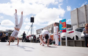 Two people dancing in white clothing at Dance-o-Mat.