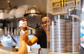 A woman serving a gelato.
