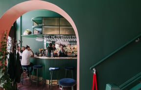View of the bar through green archway at gin gin..