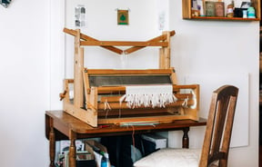 Chair next to a loom.