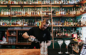 A barman making cocktails.