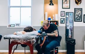A man tattooing at Union Tattoo, Wellington.