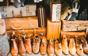 Close up of shoes and suitcases.