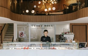 Rea Scur working behind the counter at Sweet Soul Patisserie in Christchurch.