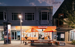 An orange cafe at night time.