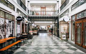 A covered arcade filled with shops.