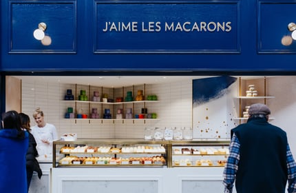 Blue shop exterior and glass cabinet of J’aime les macarons in Christchurch.