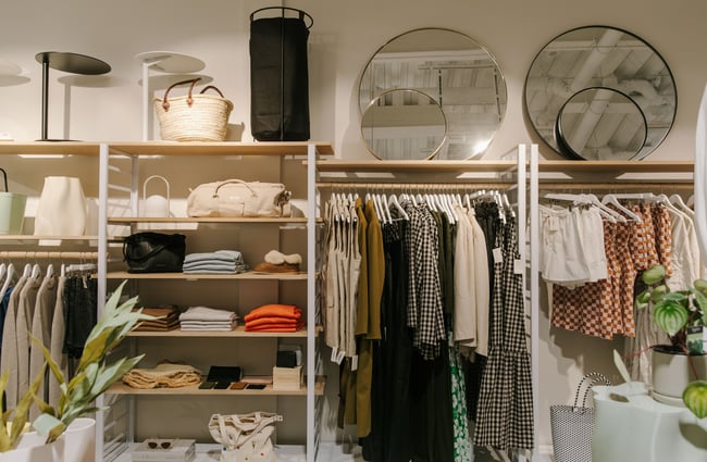 Clothes displayed on racks and shelves.