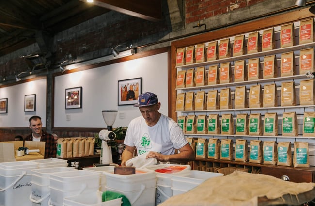 Man standing by coffee beans at Addington Coffee Co-op in Christchurch.