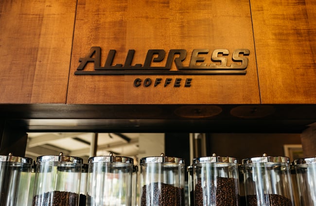 Allpress coffee sign on wood.