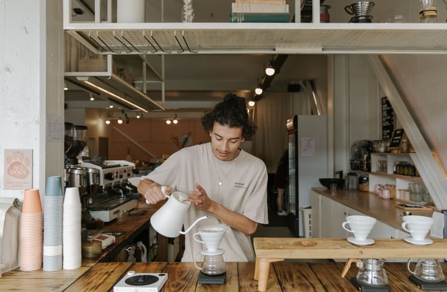 Barista prepares filter coffee at Ally & Sid café in Christchurch.