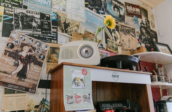 Old radio with poster clippings on the wall behind at Arthur St Kitchen, South Canterbury.