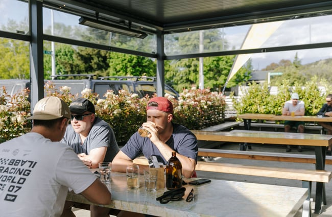 Three patrons drinking outside at b.social, Wānaka.