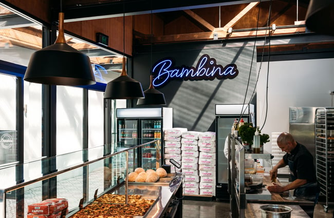 A fluorescent sign that says 'Bambina'.
