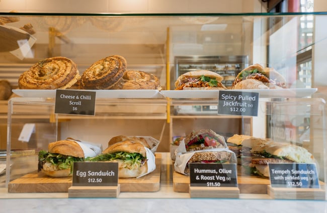 Close up of sandwiches inside a glass cabinet on the counter at Bellbird Bakery in Christchurch.