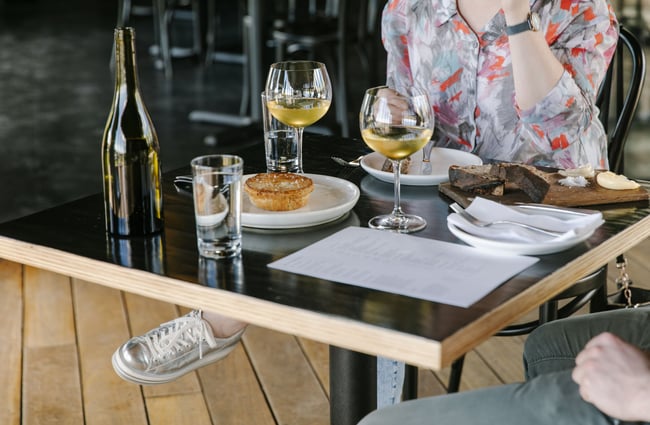 Two diners with food on the table at Black Estate, North Canterbury.