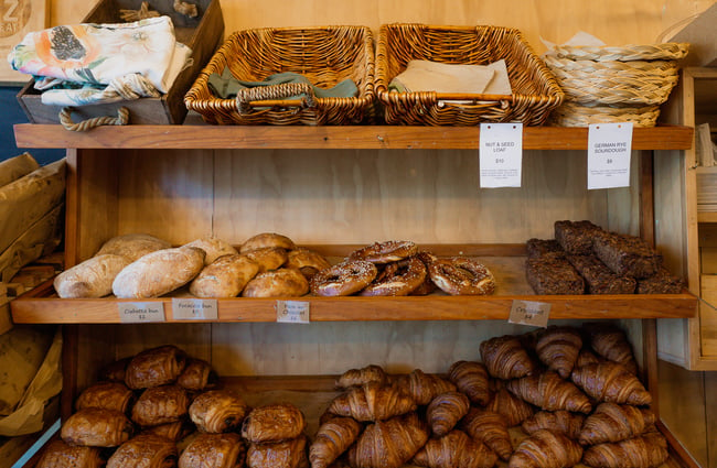 Breads on wooden shelves.