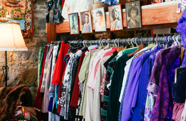 A rack of colourful vintage clothing.