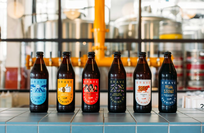 A selection of Brave Brewing beers lined up on a counter.