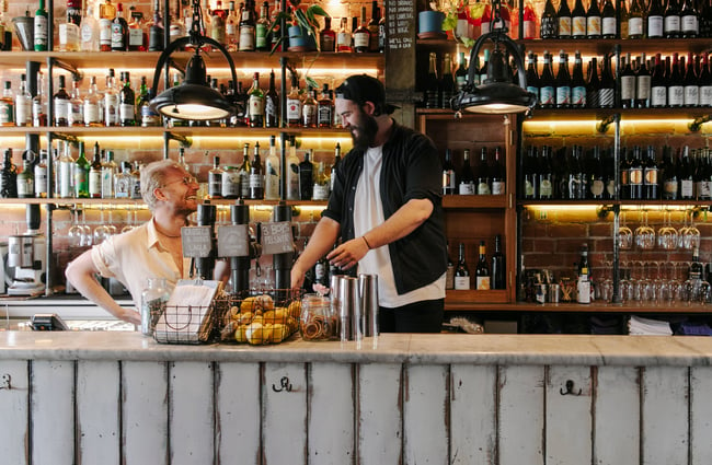 Two barmen behind the bar of Civil and Naval in Lyttelton.