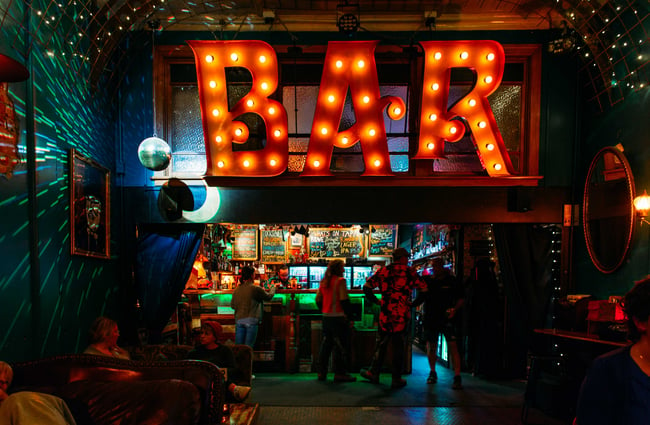 A massive sign that says 'Bar' inside Common Room in Hastings.