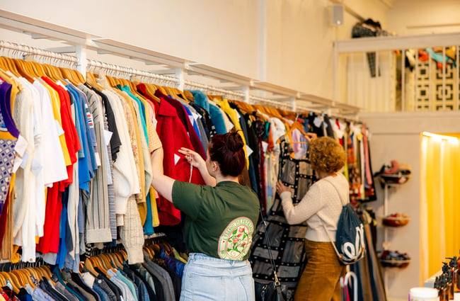 Two women browse the racks of clothes at Crushes.