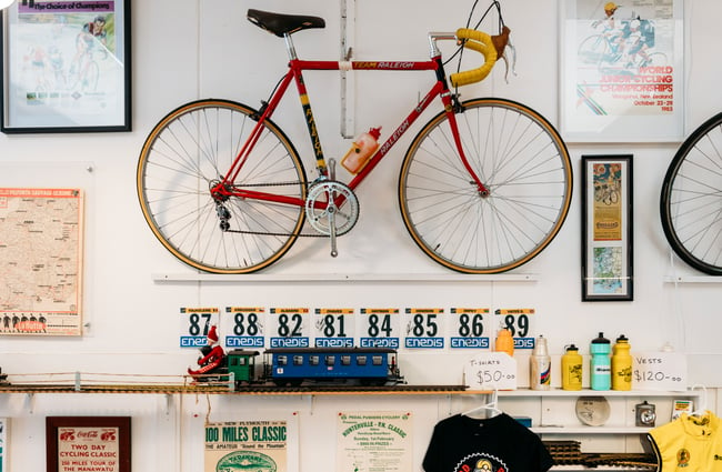 A bicycle on a wall inside a cafe.