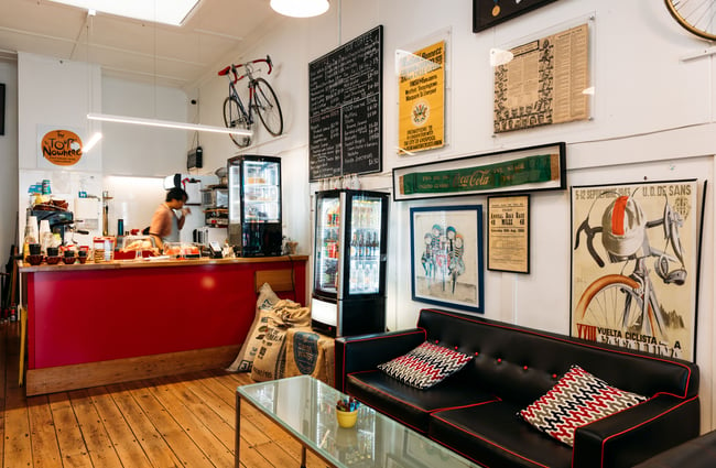 A couch and counter inside a cycling-themed cafe.