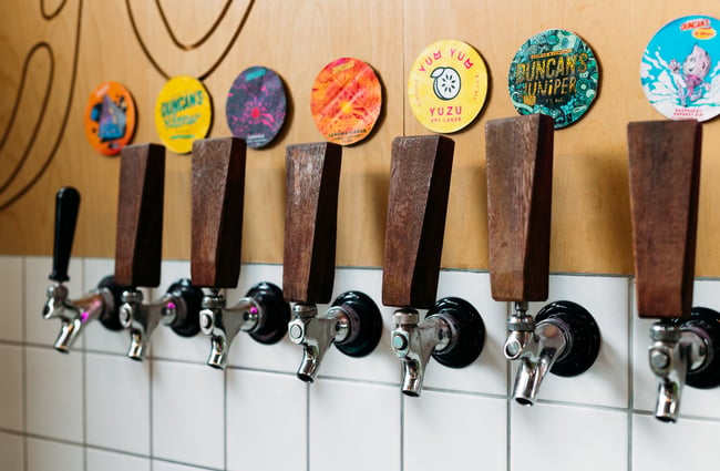 A close up of beer taps.
