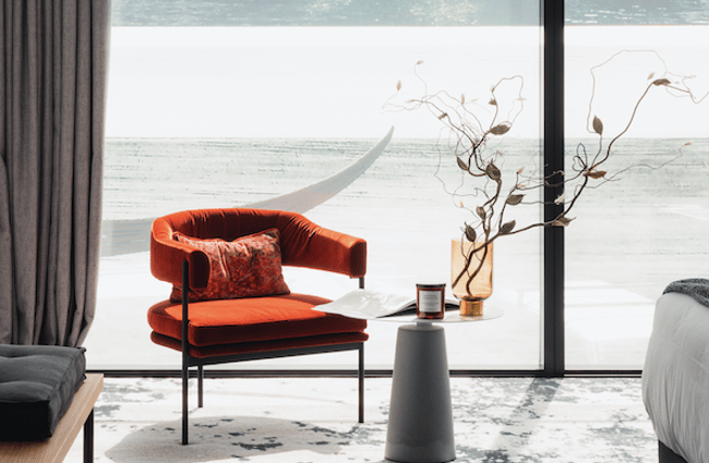 Orange armchair in room at Ebb, Dunedin.