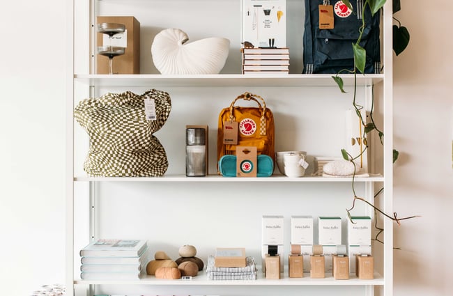 A white shelf displaying beautiful homewares.