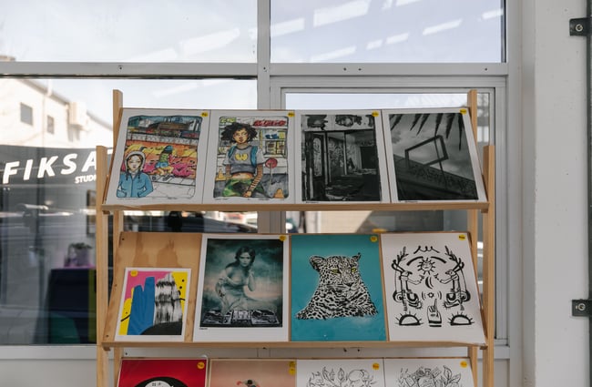 Shelves with posters for sale at Fiksate in Christchurch.