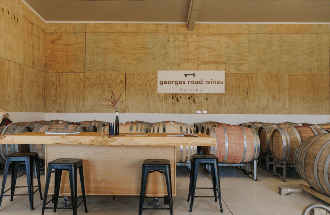 Inside the tasting room with wine barrels stacked on top of each other at Georges Road Wines in Waipara.