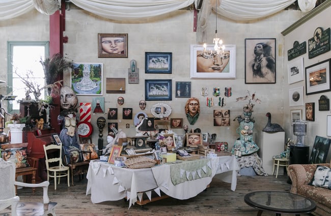 Table of artworks and curios at Grainstore Gallery in Ōamaru.