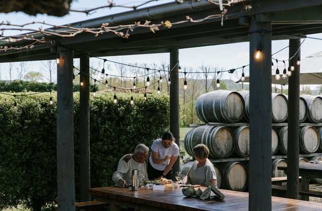 Waitress helping couple seated at an outside table at Greystone Wines, North Canterbury.