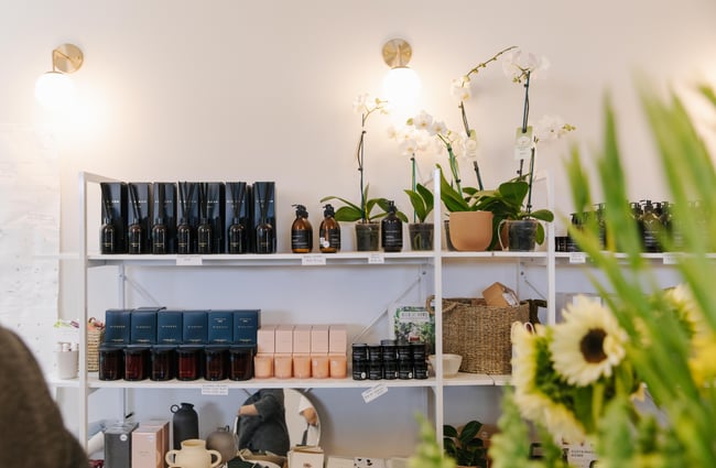 Handwash and scented candles on shelves at Harakeke Florist in Christchurch.