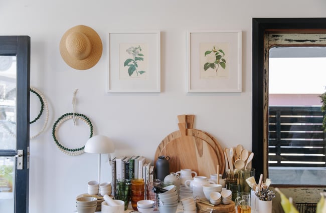 Homewares on a table and artwork on the wall at Harakeke Florist in Christchurch.