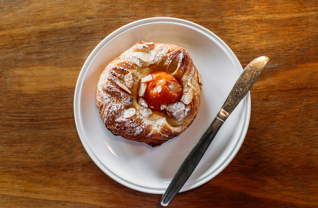A close up of an apricot pastry on a table.