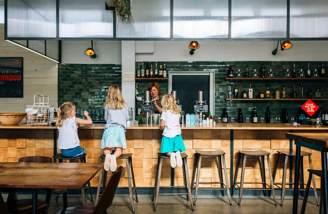 Three little girls at the counter at Hayes Common, Hamilton.