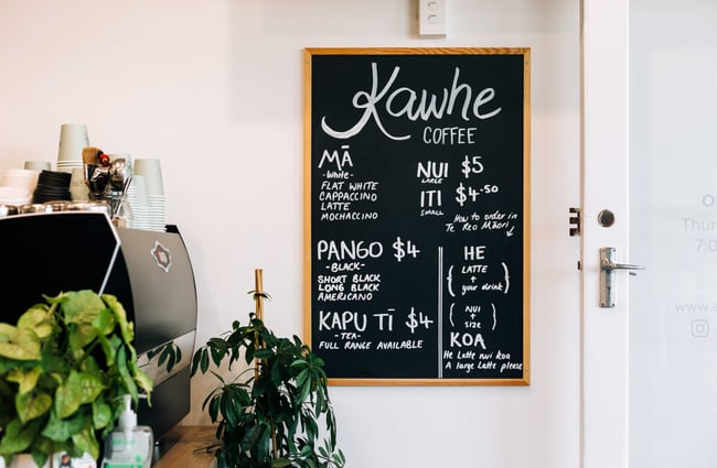 Chalkboard with kawhe prices at Knead Artisan Donuts, New Plymouth.