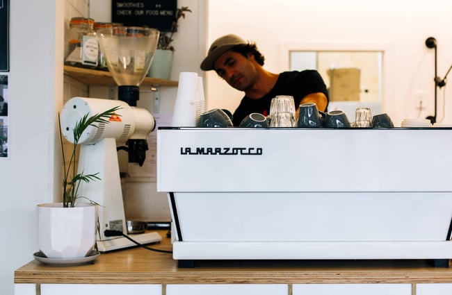 Man working on a white coffee machine.