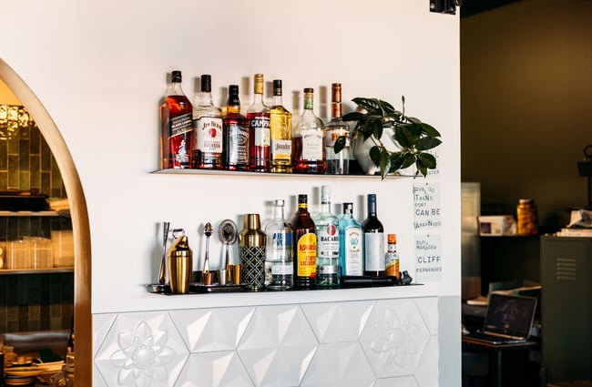 Bottles of liquor lined up on a shelf.