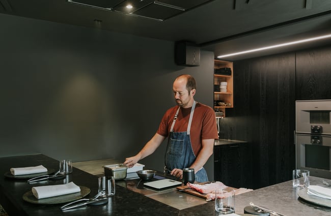 Giulio Sturla standing in his kitchen / restaurant.