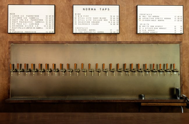The beer taps lined up along a wall at Norma Taps Auckland.