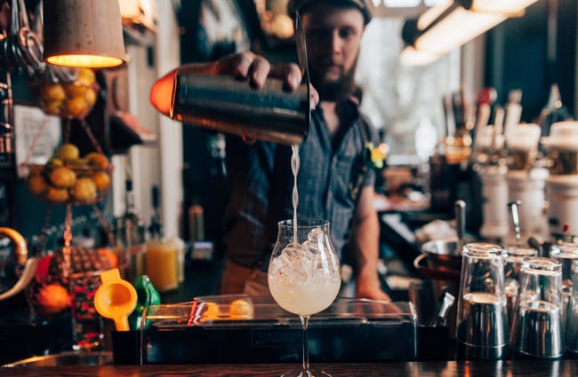 A man pouring a cocktail at OGB in Christchurch.